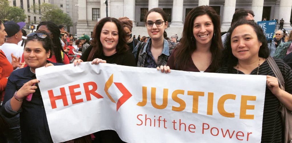 her justice staff with a banner