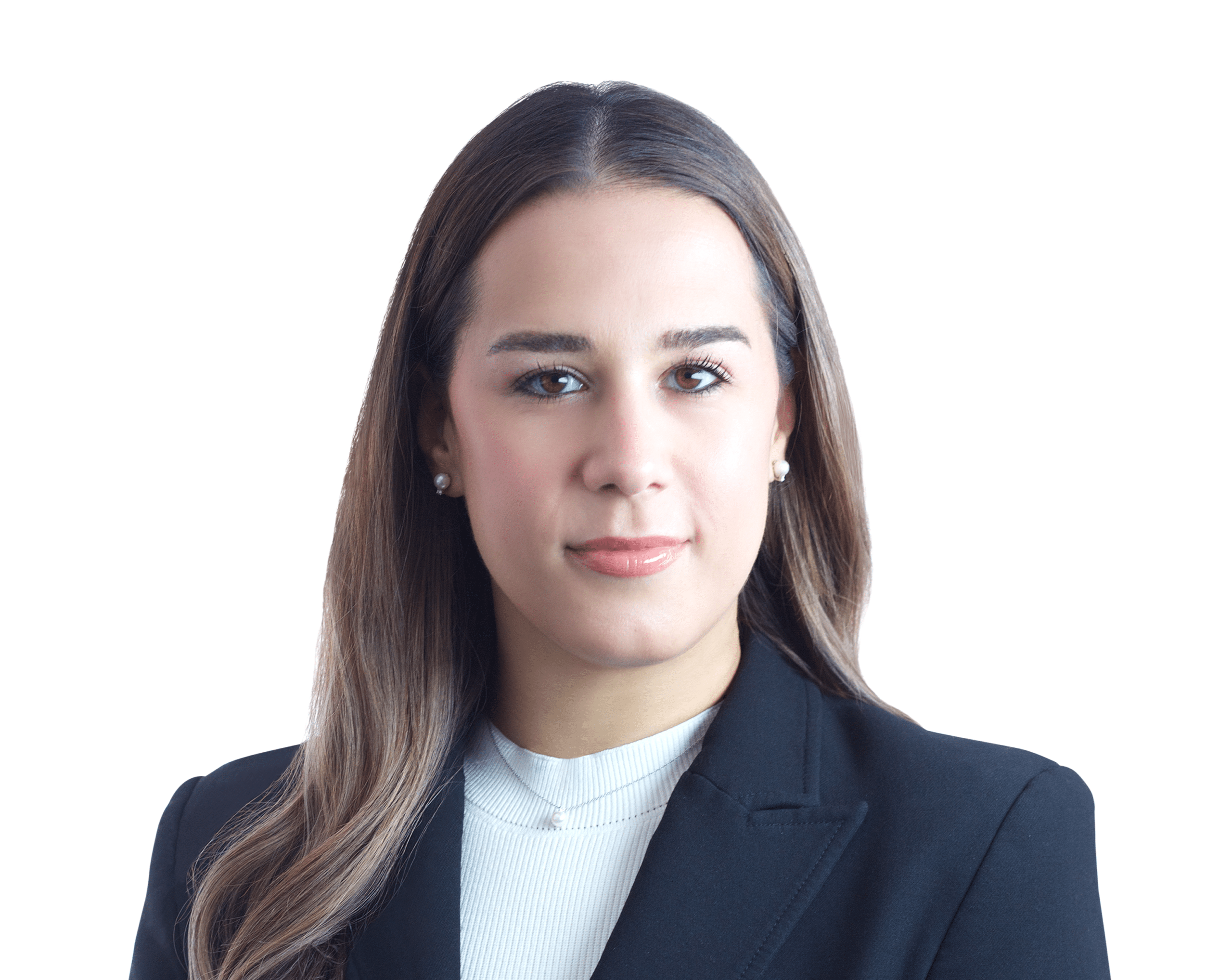 A woman with long brown hair wearing a black blazer and white top looks at the camera with a neutral expression against a plain white background.